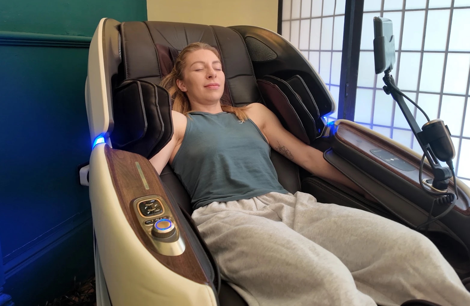 A guest resting in the AI massage chair at Floatwell Cambridge