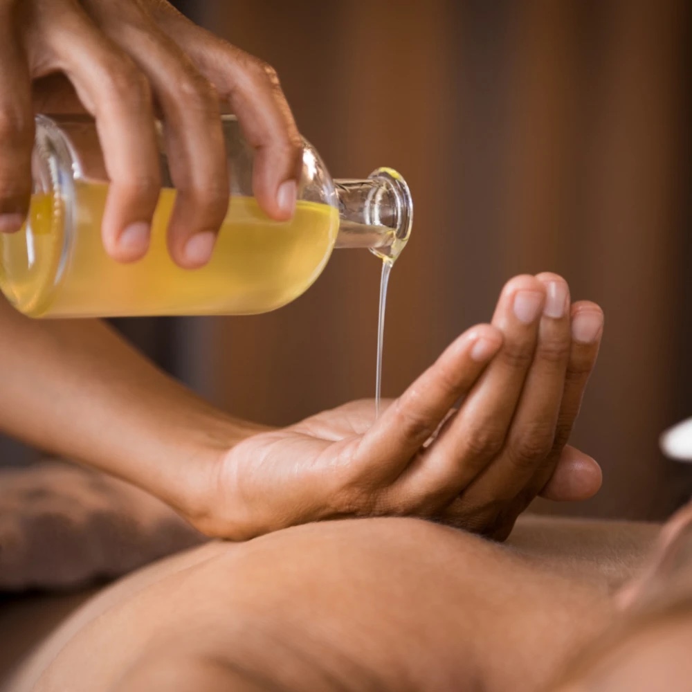 Essential oil being poured for an aromatherapy massage at Floatwell Cambridge