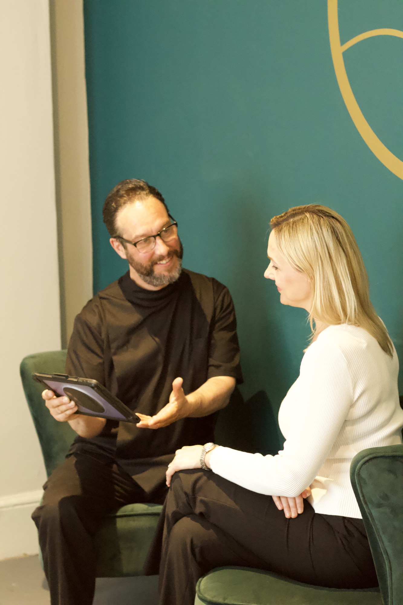 A member of the Floatwell team talking a guest through the treatment options inside the villa