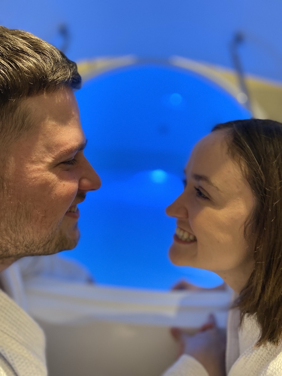 A couple beside the float pod at Floatwell Cambridge