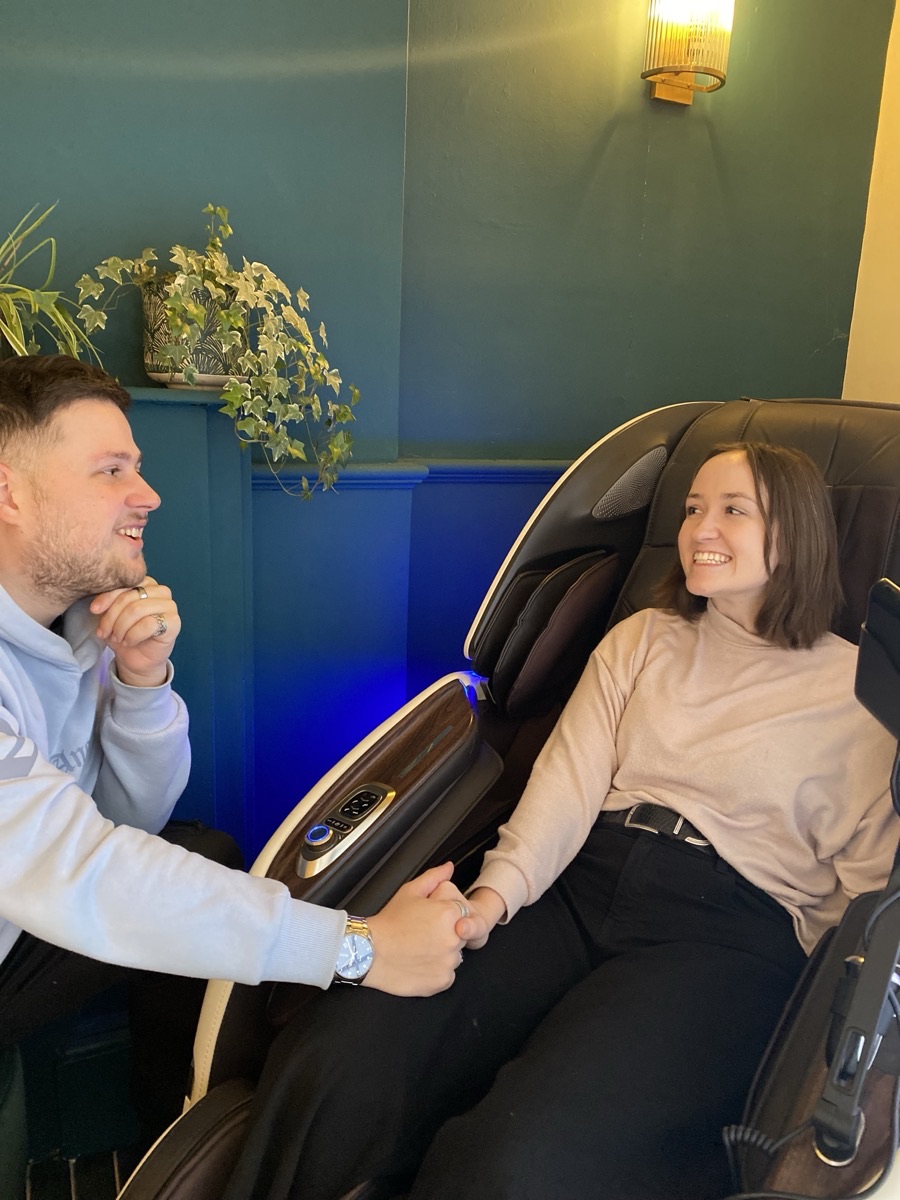 A couple together in the AI massage chair room at Floatwell Cambridge