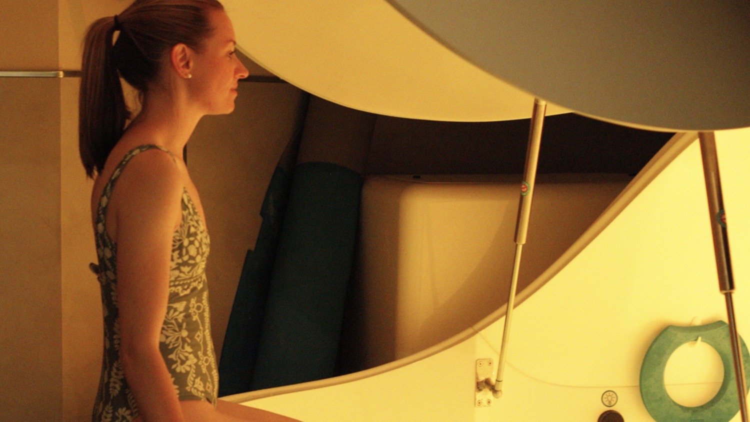 A first-time visitor standing beside an open float pod