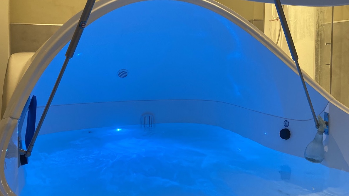 The interior of a Floatwell pod, lit blue and ready for a session