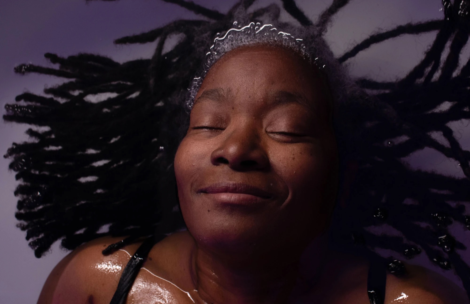 A guest floating with her eyes closed in the Epsom-salt pod at Floatwell Cambridge