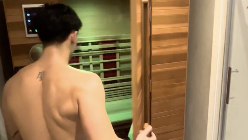 A guest opening the door of the infrared sauna cabin
