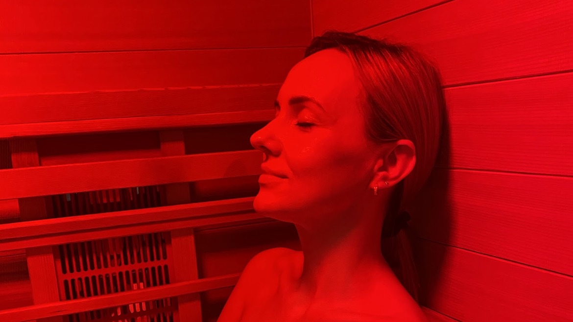 A guest resting with eyes closed in deep red infrared light